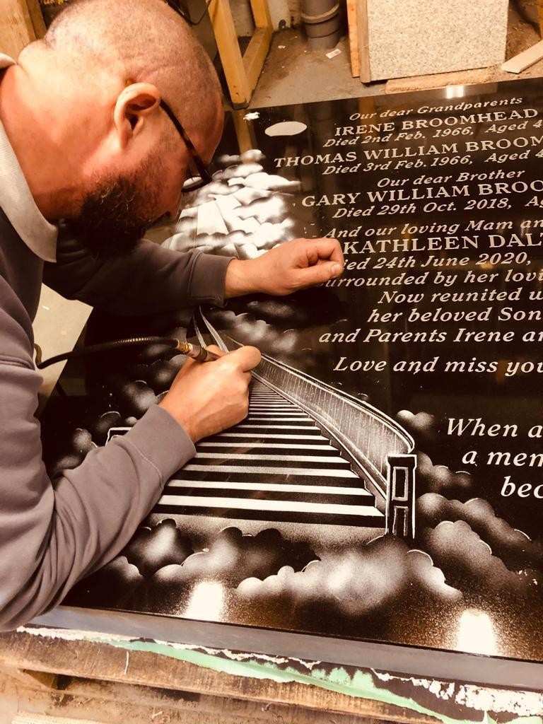 Shaun Wardingham hand-cutting lettering on a memorial